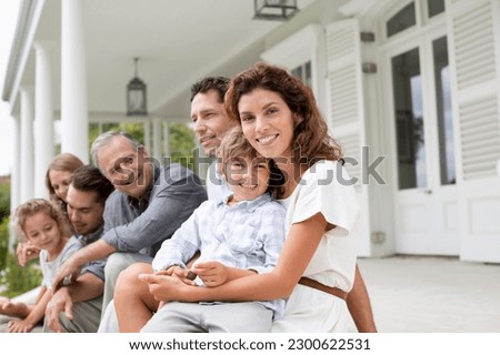 Family relaxing on porch together