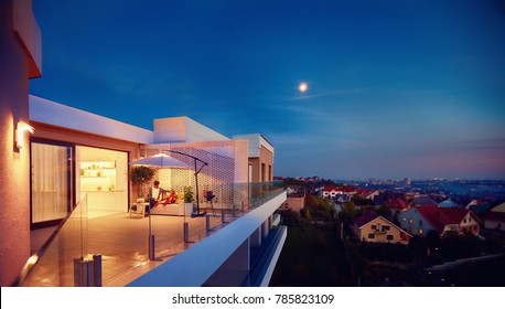 family relaxing on roof top patio with evening city view - Shutterstock ID 785823109