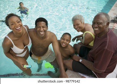 Family Relaxing In Swimming Pool