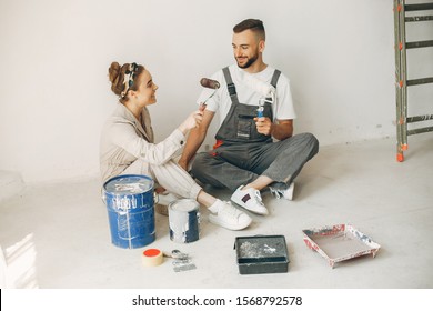 Family Repairs. Couple At Home. Woman In A Overalls