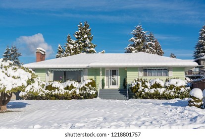 Family Residential House With Front Yard In Snow. North American House On Winter Sunny Day