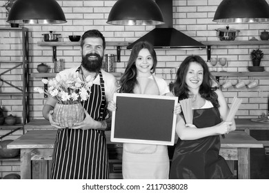 Family Restaurant Concept. Best Cooking Team. Mom Dad And Daughter Aprons In Kitchen. Lunch Time. Family Having Fun Cooking Together. Teach Kid Cooking Food. Cooking Together. Recipe Copy Space