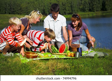 Family Resting On The Lake