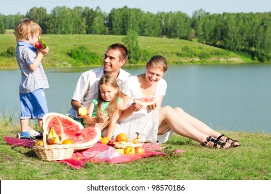 Family Resting On The Lake