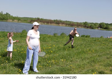 Family resting on a river bank in summer