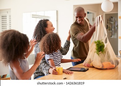 Family Returning Home From Shopping Trip Unpacking Plastic Free Grocery Bags - Powered by Shutterstock