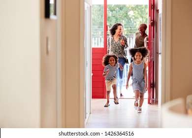 Family Returning Home From Shopping Trip Using Plastic Free Grocery Bags Opening Front Door - Powered by Shutterstock