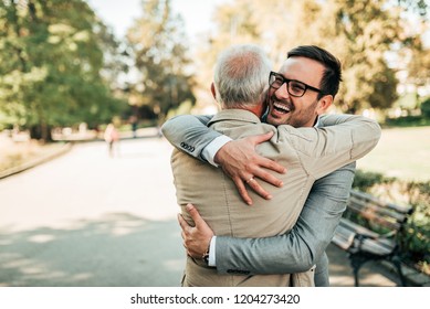 Family reunion. Father and son hugging outdoors. - Powered by Shutterstock