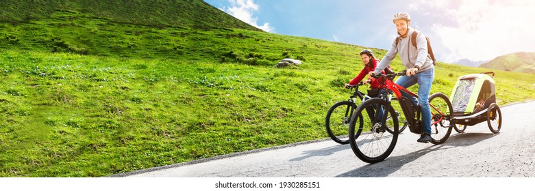 Family Riding Electric Mountain Bike Or Bicycle In Mountains