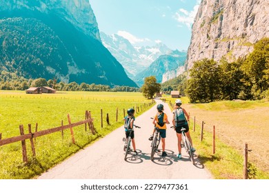 Family riding on mountain bike in Switzerland