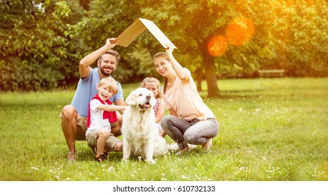 Family with roof over their heads as house construction goal concept - Powered by Shutterstock