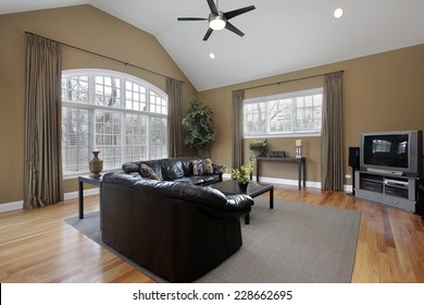 Family Room With Large Picture Window And Brown Walls 