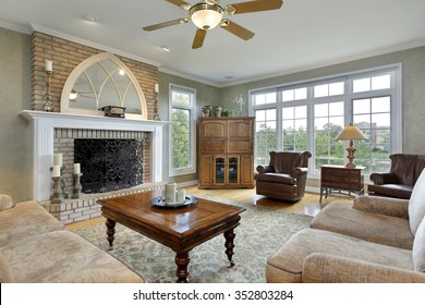 Family Room In Luxury Home With Large Brick Fireplace