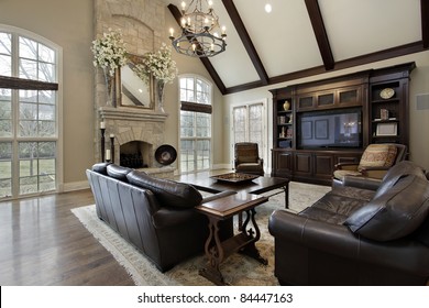 Family Room In Luxury Home With Two Story Stone Fireplace