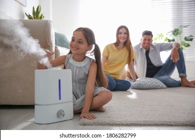 Family In Room With Modern Air Humidifier