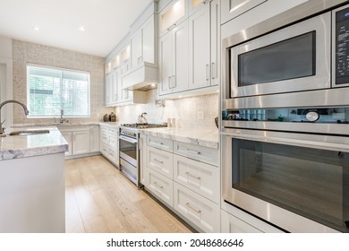 Family Room Open Concept With Kitchen Large Sectional Sofa White Countertops And Cabinets Eating Counter And Tv Area