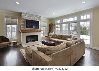 Family Room With Wood And Stone Fireplace