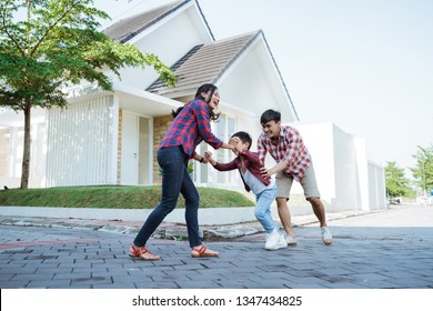 Family Running Around Together While Playing And Have Fun At Home