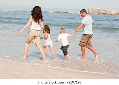 Family Running On Beach Stock Photo (Edit Now) 72197128