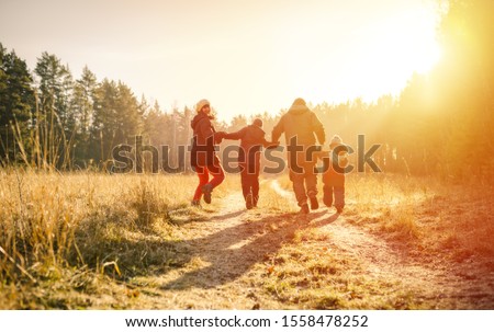 family running on country road in autumn time