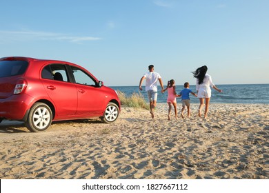 Family Running On Sandy Beach. Summer Trip