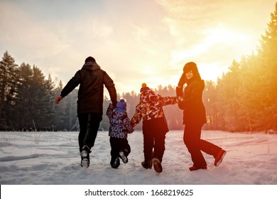 Family Running On The Snow In Wintertime