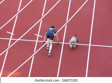 Family  Running On The Track In Stadium