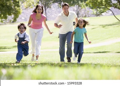 Family Running Outdoors Smiling