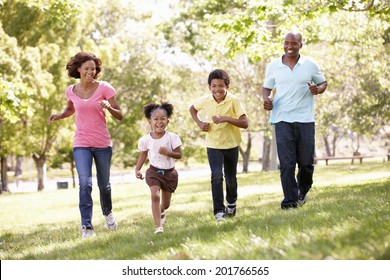 Family Running In Park