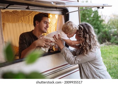 Family rv trip: young parents on vacation with little son living in motor house, modern camper trailer. Active family travel in caravan. Recreation lifestyle and summer vacation with kid in motor home