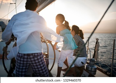 Family Sailing At Sunset