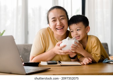 Family Saving Money Concept, Asian Woman And Son Note Family Expenditures For A Plan To Spend The Future In Earnest, Family And Financial Concept, Finance And Saving, Save Money. Family Budget Plan.