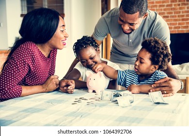 Family saving money to piggy bank