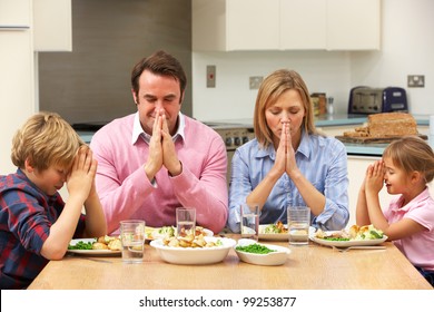 Family Saying Grace Before Meal