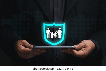 Family security concept. Businessman holding smartphone virtual screen, family icon in security icon. insurance business, life insurance, future planning long term financial investment.