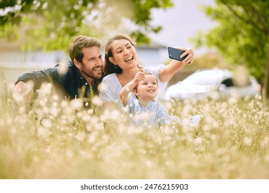 Family, selfie and nature with flowers, field and trees for bonding, love and social media together outdoor. Woman, kid and man playing at park in summer for happy, memory and post for live streaming - Powered by Shutterstock