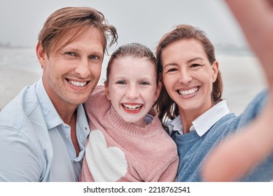 Family Selfie Portrait At Beach Holiday, Summer Vacation And Relaxing Sea Together. Video Call Faces Of Excited, Smile And Happy Mom, Dad And Girl Kid Photos For Fun, Happiness And Sunny Ocean Travel