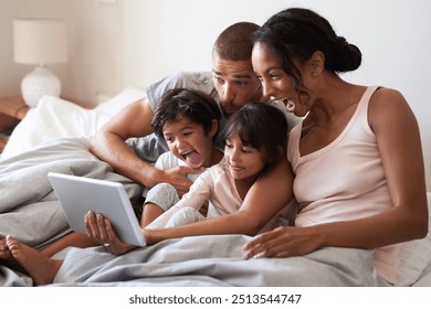 Family, selfie and tablet on bed for playful, relax and live streaming together with video and app. Parents, silly and children as people in home bedroom for film, social media and memory on weekend - Powered by Shutterstock