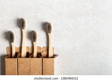 A family set of four eco friendly wooden bamboo toothbrushes. Say no to plastic concept. Top view, flatlay, copy space - Powered by Shutterstock