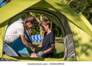 Family setting up a tent camping on a grassy overlooking the calm lake family enjoys a shared activity is relaxed outdoor holiday adventure experience of nature and outdoor recreation. - Powered by Shutterstock