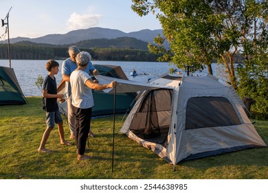 Family setting up a tent camping on a grassy overlooking the calm lake family enjoys a shared activity is relaxed outdoor holiday adventure experience of nature and outdoor recreation. - Powered by Shutterstock