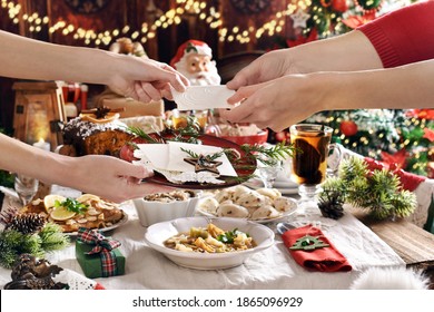 Family Sharing Christmas Eve Wafer At The Festive Table With Traditional Dishes