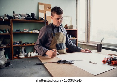 In A Family Shoe Shop A Young Apprentice Works With Paper To Create A Pattern For Shoes.