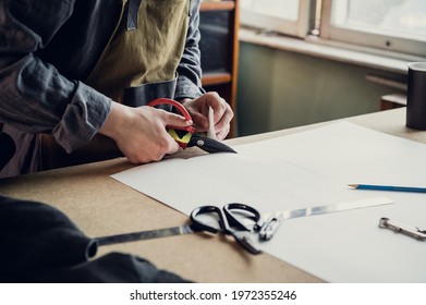 In A Family Shoe Shop A Young Apprentice Works With Paper To Create A Pattern For Shoes