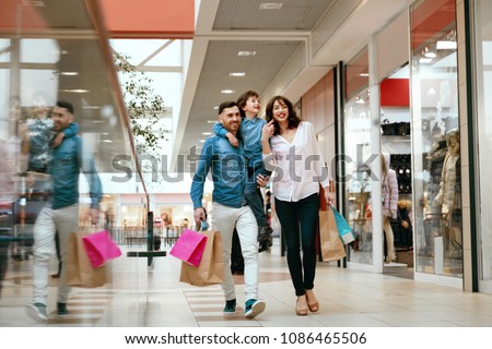 Family Shopping. Happy People In Mall