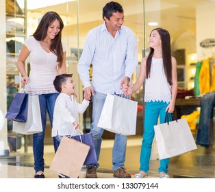 Family Shopping At The Mall And Looking Very Happy