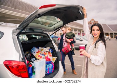 Family At Shopping . Family On The Car Parked Near The Car