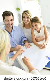 Family Signing Contract With Home Seller