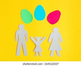 Family Silhouette On Yellow Background, Little Girl Raised Hands Up To Easter Eggs. Easter Celebration Concept.