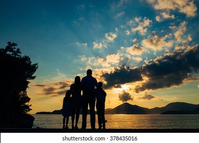 Family Silhouette In The Sunset